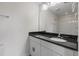 Bathroom featuring a vanity with black countertop, white cabinets, and chrome fixtures at 7780 Montview Rd, North Charleston, SC 29418