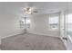 Neutral bedroom featuring plush carpet, three bright windows, and a ceiling fan at 7780 Montview Rd, North Charleston, SC 29418
