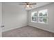 Bedroom featuring carpet, two bright windows, and a ceiling fan at 7780 Montview Rd, North Charleston, SC 29418