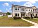 Two-story townhome features neutral siding, well-maintained lawn, and pathway leading to the entrance at 7780 Montview Rd, North Charleston, SC 29418