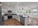 Bright kitchen featuring white cabinets, stainless steel appliances, and a sleek black countertop island at 7780 Montview Rd, North Charleston, SC 29418