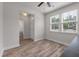 Cozy living room features neutral walls, wood flooring, and abundant natural light from large windows at 7780 Montview Rd, North Charleston, SC 29418
