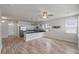 An open concept living space with hardwood flooring, ceiling fan, and a view into the kitchen at 7780 Montview Rd, North Charleston, SC 29418