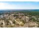 Scenic aerial view of property with home and metal building, near ocean and wooded area at 8476 Old Georgetown Rd, McClellanville, SC 29458
