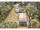 Aerial perspective of a house and detached garage, set on a generous lot with mature trees at 8476 Old Georgetown Rd, McClellanville, SC 29458