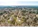 Wide aerial view of property featuring a home and metal building, surrounded by trees at 8476 Old Georgetown Rd, McClellanville, SC 29458