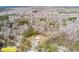 Aerial view showcases the full boundaries of home and metal building within wooded lot at 8476 Old Georgetown Rd, McClellanville, SC 29458