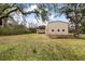 View of house and detached garage shed with fenced area from the spacious grass backyard at 8476 Old Georgetown Rd, McClellanville, SC 29458