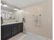 Bright bathroom featuring a double vanity with neutral walls and light tile flooring at 8476 Old Georgetown Rd, McClellanville, SC 29458