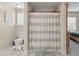 Neutral bathroom featuring a toilet and shower/tub with striped curtain at 8476 Old Georgetown Rd, McClellanville, SC 29458
