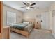 Bright bedroom features neutral walls, ceiling fan, and a cozy bed with light wood frame at 8476 Old Georgetown Rd, McClellanville, SC 29458