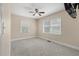 Spacious, carpeted bedroom with neutral walls and two windows providing natural light at 8476 Old Georgetown Rd, McClellanville, SC 29458