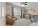 Bedroom featuring a crib, dresser, and chair near a large window with natural light at 8476 Old Georgetown Rd, McClellanville, SC 29458