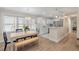 Bright dining area with a wooden table, and a view into the adjacent kitchen, creating an inviting space for meals and gatherings at 8476 Old Georgetown Rd, McClellanville, SC 29458