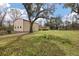 Spacious property featuring a large metal building and a charming home surrounded by lush greenery at 8476 Old Georgetown Rd, McClellanville, SC 29458