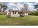 Charming single-story home with neutral siding, inviting front porch and an American flag flying high, showcasing its curb appeal at 8476 Old Georgetown Rd, McClellanville, SC 29458