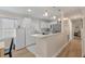Bright kitchen boasts white cabinets, marble countertops, and stainless steel appliances at 8476 Old Georgetown Rd, McClellanville, SC 29458