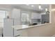 Bright kitchen boasts white cabinets and granite countertops at 8476 Old Georgetown Rd, McClellanville, SC 29458