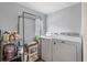 Practical laundry room with modern washer and dryer, storage shelves, and gray walls at 8476 Old Georgetown Rd, McClellanville, SC 29458