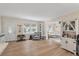Open living room with hardwood floors, and a view into the adjacent sitting room, showcasing the spacious and inviting layout at 8476 Old Georgetown Rd, McClellanville, SC 29458