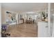Bright, open-concept living space with hardwood floors, dining area, and a glimpse of the adjacent living room, perfect for entertaining at 8476 Old Georgetown Rd, McClellanville, SC 29458