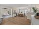 Bright, open-concept living space with hardwood floors, dining area, and a glimpse of the adjacent living room, perfect for entertaining at 8476 Old Georgetown Rd, McClellanville, SC 29458
