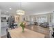 Inviting open concept with dining table, breakfast bar and living area, showcasing the seamless flow and functionality of the layout at 8476 Old Georgetown Rd, McClellanville, SC 29458