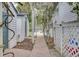 Charming backyard featuring a trellis, walkway, outbuildings, and a glimpse of a refreshing pool at 8774 Adaline St, North Charleston, SC 29406