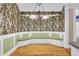 A dining nook with a light-green bench seat and floral wallpaper at 8774 Adaline St, North Charleston, SC 29406