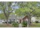 Charming single-story home featuring a well-manicured lawn, mature trees, and inviting curb appeal at 8774 Adaline St, North Charleston, SC 29406
