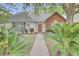 Lovely home with lush landscaping, a brick-accented facade, and a welcoming pathway to the front door at 8774 Adaline St, North Charleston, SC 29406