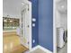 A blue hallway featuring views of a laundry room and a dining nook at 8774 Adaline St, North Charleston, SC 29406