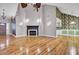 Bright, open living room with hardwood flooring, a cozy fireplace, and decorative wall sconces at 8774 Adaline St, North Charleston, SC 29406