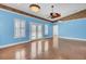 Bright living room with blue walls, tile floor, ceiling fan, and French doors to a pool at 8774 Adaline St, North Charleston, SC 29406