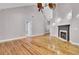 Open-concept living room with hardwood floors and a fireplace that is great for entertaining at 8774 Adaline St, North Charleston, SC 29406