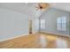 Bright main bedroom with hardwood floors, two large windows and access to a Primary bath at 8774 Adaline St, North Charleston, SC 29406