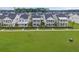 New construction homes showcase charming exteriors, complemented by a large green lawn and manicured landscaping at 886 Clay Field Trl, Summerville, SC 29485