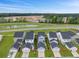 Aerial view of new construction homes, featuring attached garages and a pond in the distance at 886 Clay Field Trl, Summerville, SC 29485