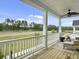 Scenic back porch with seating and stunning views of the landscape and community at 886 Clay Field Trl, Summerville, SC 29485