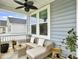Inviting outdoor porch area with comfortable wicker furniture and views of the neighborhood at 886 Clay Field Trl, Summerville, SC 29485