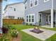Backyard patio area featuring a fire pit with landscaping and a view of siding at 886 Clay Field Trl, Summerville, SC 29485