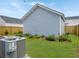 Backyard features a detached garage, landscaping, string lights and an AC unit at 886 Clay Field Trl, Summerville, SC 29485