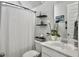 Bright bathroom featuring white fixtures, decorative shelves, and a serene atmosphere at 886 Clay Field Trl, Summerville, SC 29485