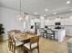 Open-concept kitchen and dining room with stylish lighting and hardwood floors at 886 Clay Field Trl, Summerville, SC 29485
