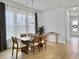 Well-lit dining room with a wooden table and chairs adjacent to a hallway and entrance at 886 Clay Field Trl, Summerville, SC 29485