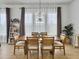 Bright dining room with wooden table, seating for six, and a bookshelf filled with books at 886 Clay Field Trl, Summerville, SC 29485