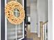 Entryway showing decorative wreath on the front door and stairway at 886 Clay Field Trl, Summerville, SC 29485