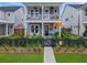 Charming two-story home with a welcoming front porch and a black picket fence at 886 Clay Field Trl, Summerville, SC 29485