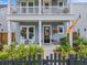 Close-up of front porch featuring hanging plants and a decorative wreath at 886 Clay Field Trl, Summerville, SC 29485
