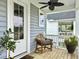 Charming front porch with gray siding and a comfortable seating area at 886 Clay Field Trl, Summerville, SC 29485